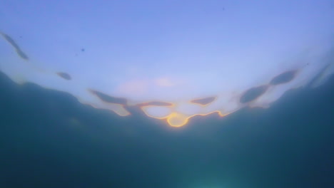 sunset-from-under-water-with-abstract-water-ripples-and-beautiful-color-pattern