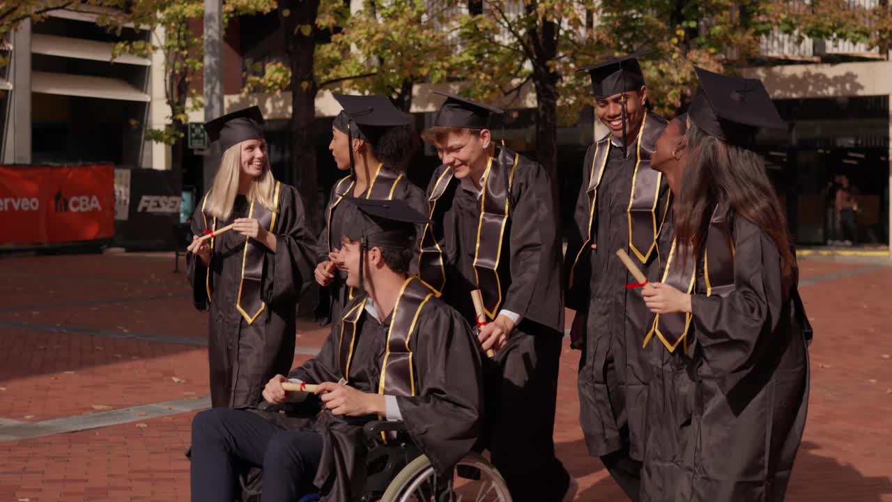 Diverse Graduates Celebrating with Wheelchair-Bound Student