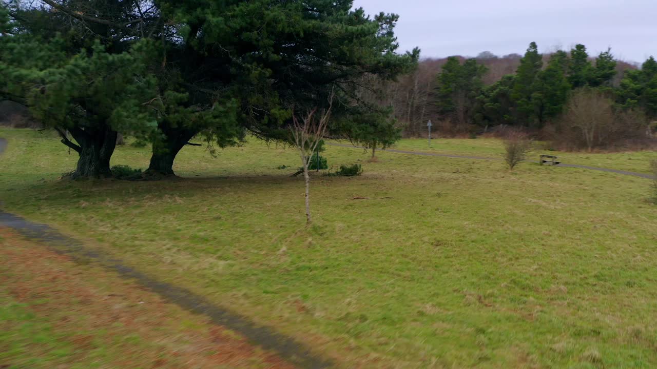 Smooth aerial pullback of Barna Swan Sanctuary, revealing the grassy park. Galway
