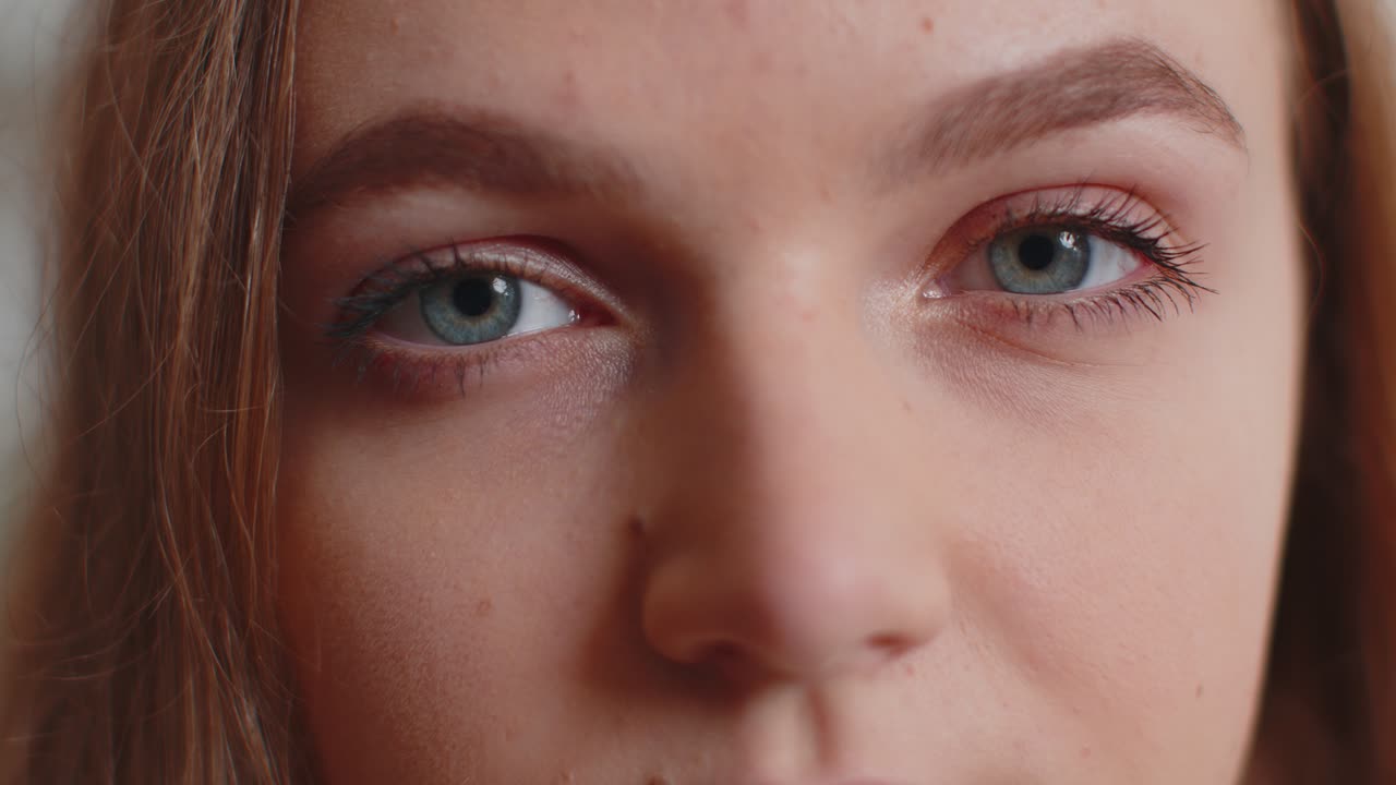 Closeup macro portrait of beauty young beautiful womans eyes smiling model looking at camera