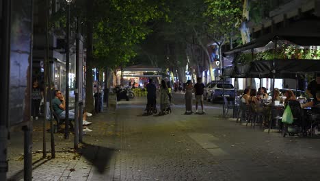 people dining and walking on a lively street