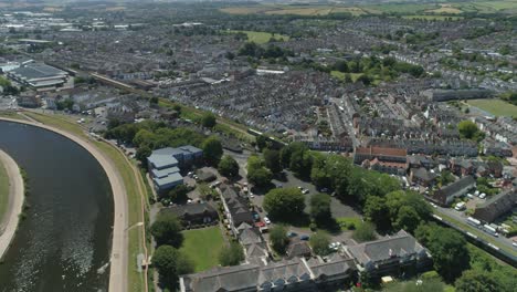 Aerial-of-a-passenger-train-moving-through-a-city-landscape