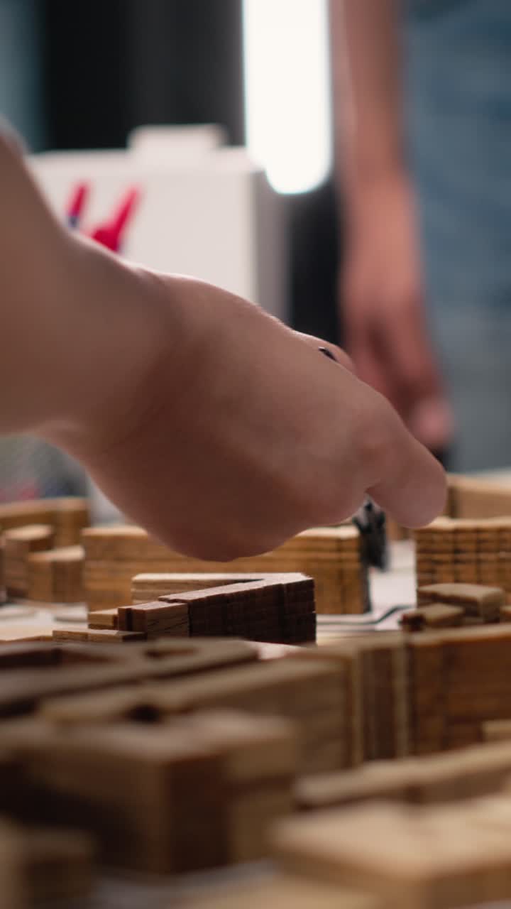 Vertical Video Close up of contractors arranging layout for a housing master plan