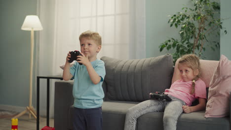 toddler and preschooler play difficult game with consoles