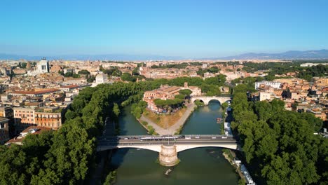 drone ascends to reveal tiber island along tiber river in downtown rome, italy