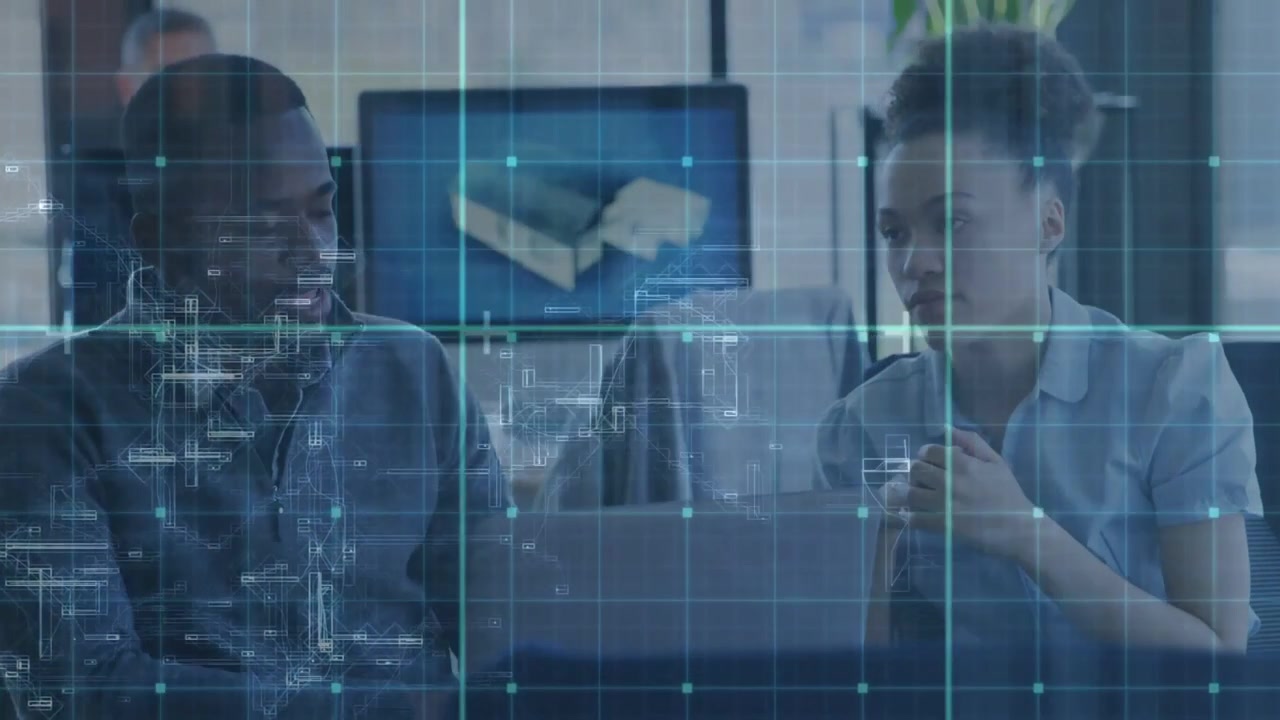 Right person pointing at laptop causing blue HUD showing 3D model on monitor left replying tech
