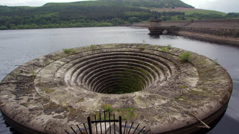 wide shot of the bellmouth overflow looking up the reservoir