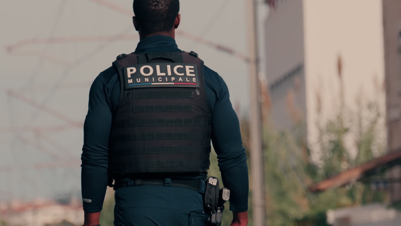 Two french police officers walking and patrolling the streets in Nice, France