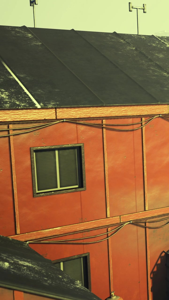 Red building with windows and power lines in urban setting at sunset