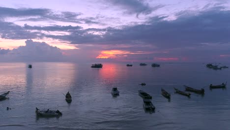 white boat silhouetted against sunset