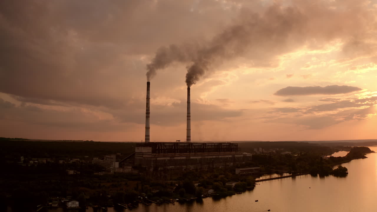 High voltage post. High-voltage tower sky background, factory pipe with smoke over it. Earth pollution and industrialization concept. Selective focus