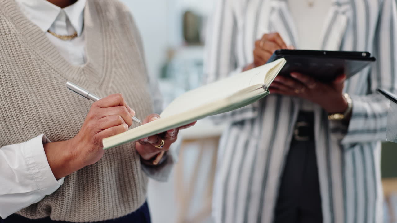 Businesswomen collaborating on plans in office