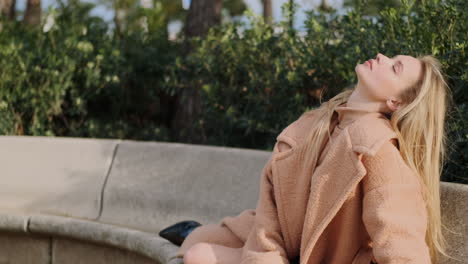 young woman resting on bench in the park.