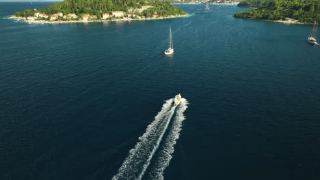 motorboat cruising on high speed between korcula island on a sunny day