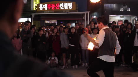 fire juggler performance in a city street