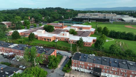 Zoom-out-of-school-building-and-neighborhood-of-row-homes