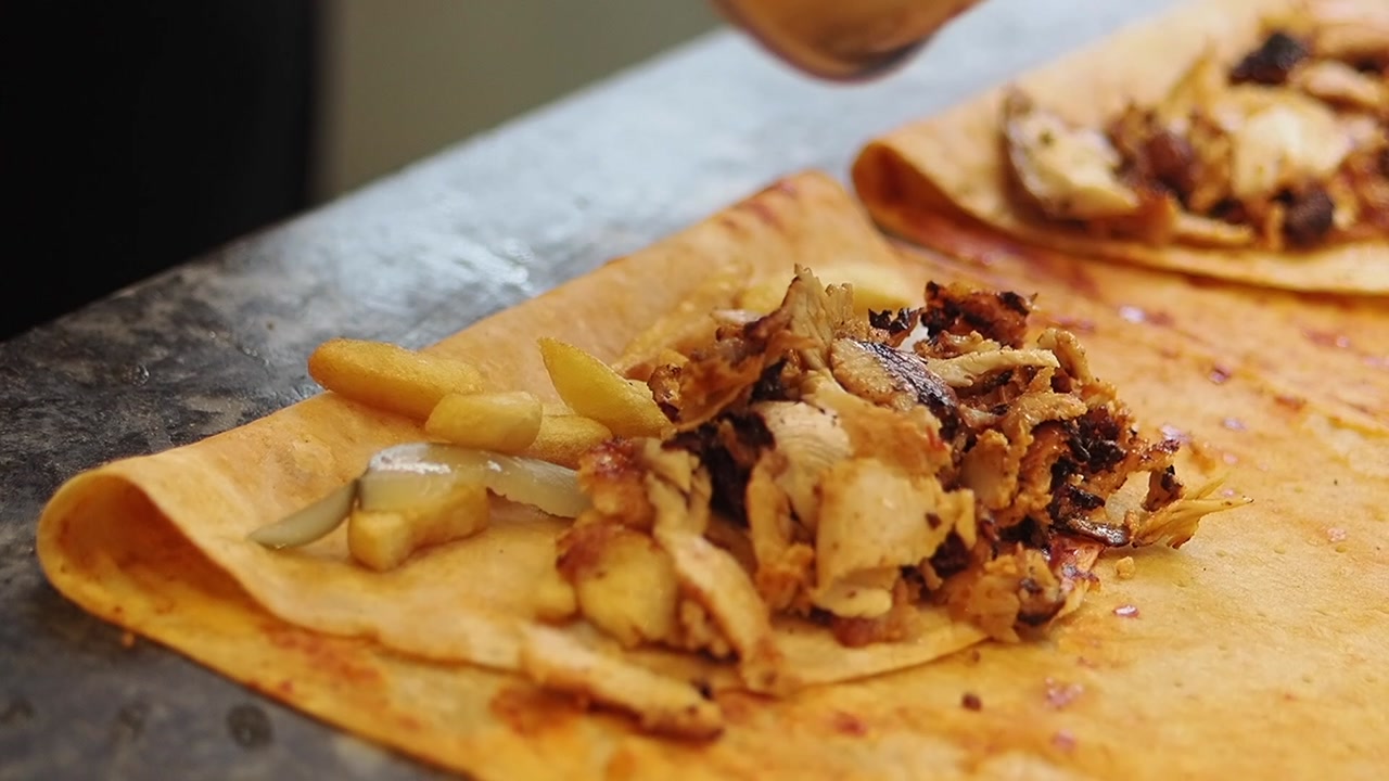 Chef Preparing Chicken Shawarma Wrap with French Fries