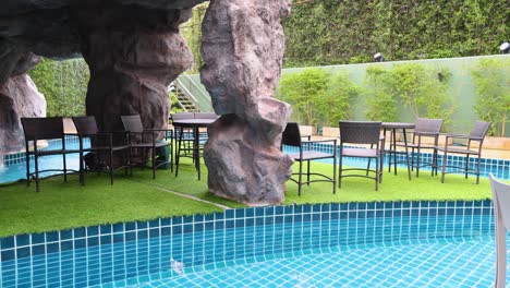 outdoor seating area by a poolside cave