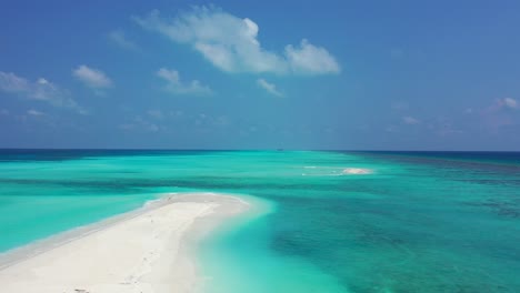 white sand sandbar in the middle of the endless turquoise sea