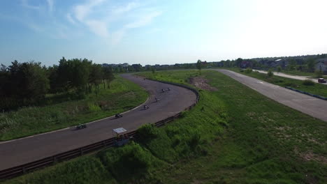 motorcyclist ride on race track in countryside road. drone view moto competition
