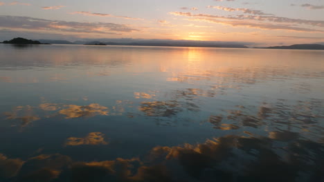 beautiful coloured sky and clouds reflecting in the still ocean waters of the whitsunday islands during sunrise