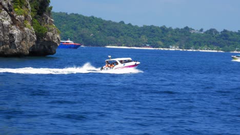 Speedboat-sails-through-blue-Andaman-sea-at-Koh-Phi-Phi-island-in-Thailand