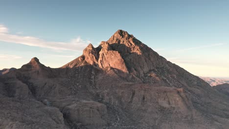 Aerial-dolly-in-of-mountain-hill-landscape-peak-at-day-in-Baja,-Mexico