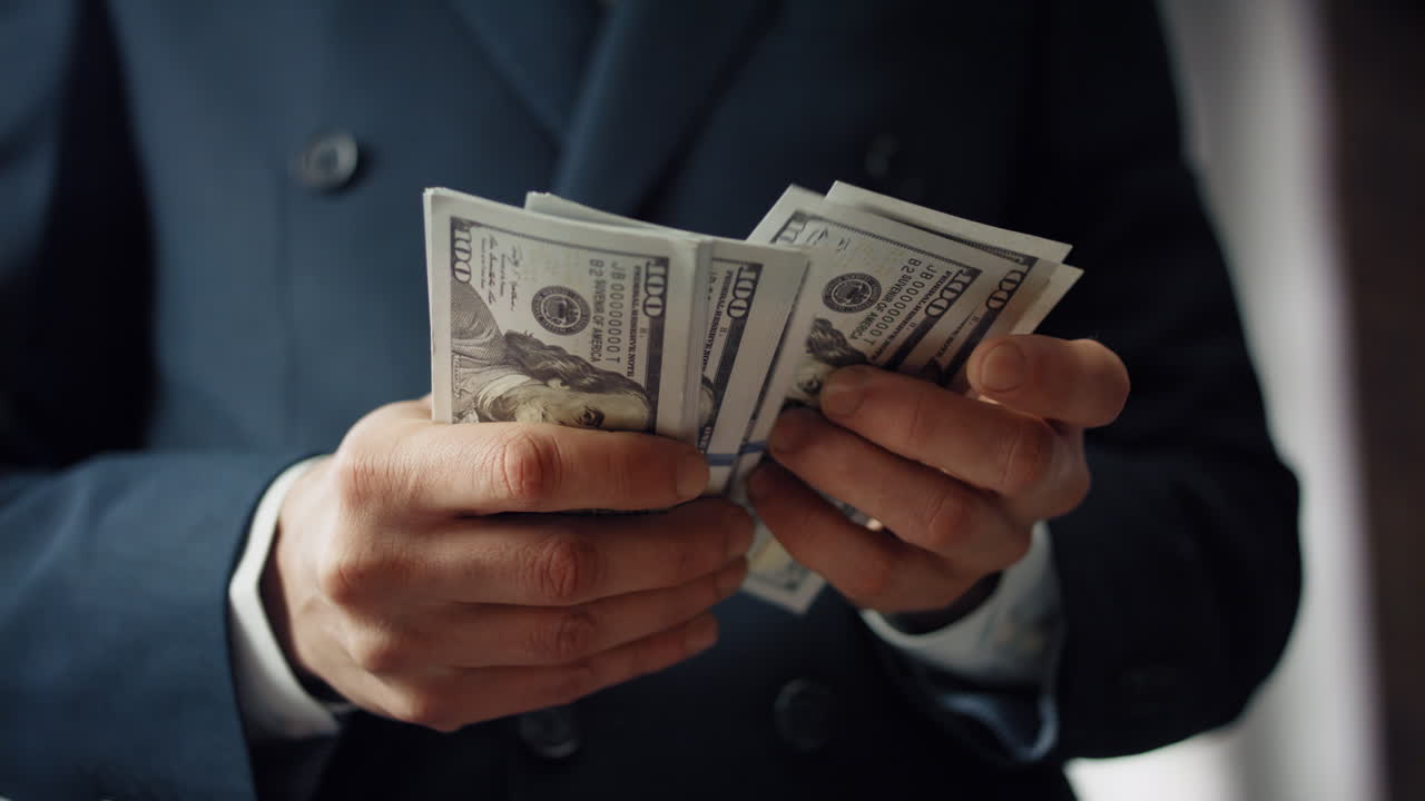 Male hands counting money cash close up. Unknown man calculating dollar bills.