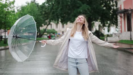 Carefree-young-blonde-woman-lets-the-refreshing-spring-rain-fall-down-on-her