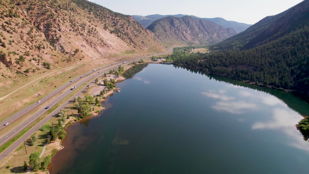 Aerial footage of Georgetown Lake in Georgetown Colorado. Cars can be seen driving on the left side of video.