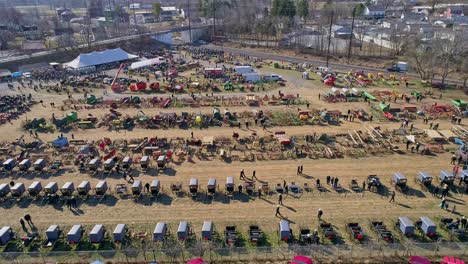 an aerial view of an amish mud sale with buggies, farm equipment and other crafts in early spring