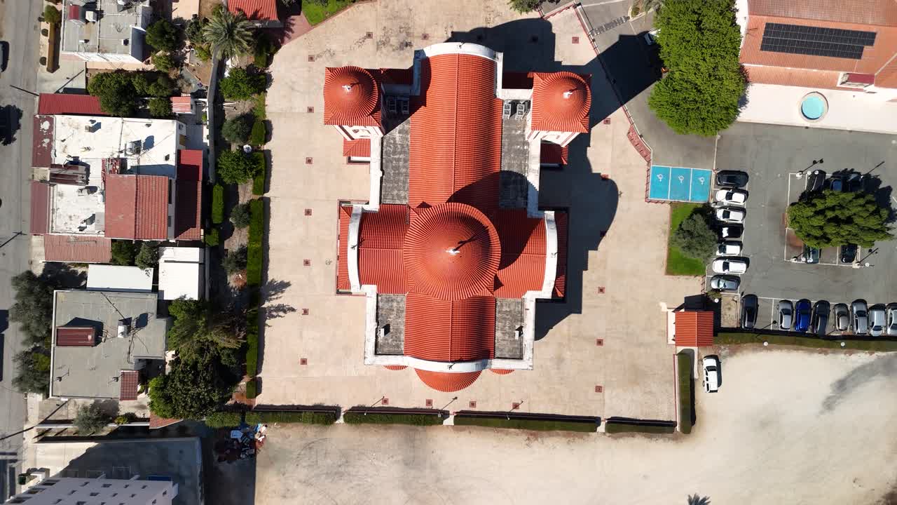An aerial perspective captures the remarkable design of a domed structure with engaging tile patterns. Visitors enjoy the peaceful surroundings as the sun shines above