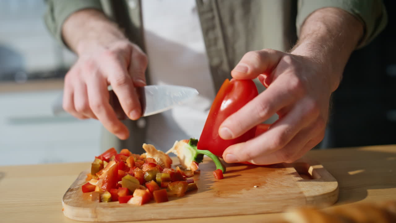 Man hands preparing vegetables ingredients for salad on home kitchen closeup
