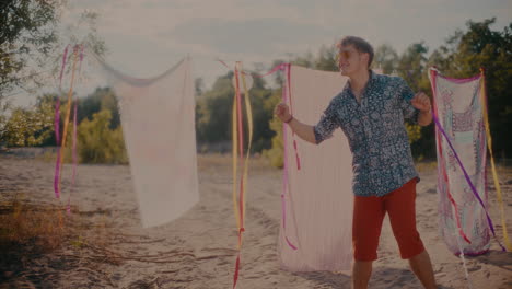 smiling handsome man enjoying music while grooving at beach