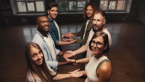 first person view of six people putting their hands up to catch you while you fall. practicing trust in group therapy