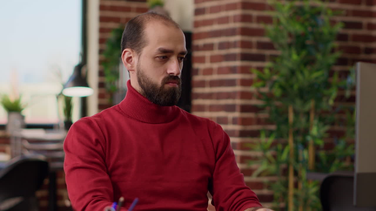 Portrait of office worker using computer to develop analysis