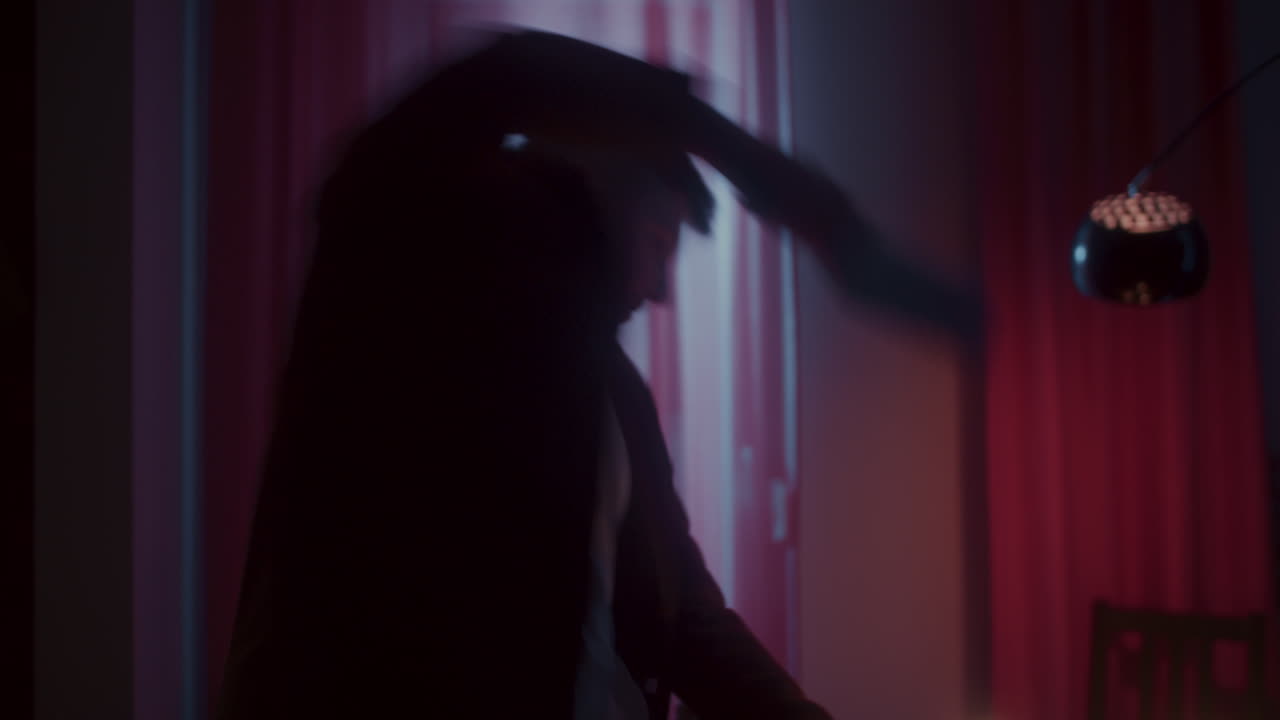 Man cooking in a dimly lit room