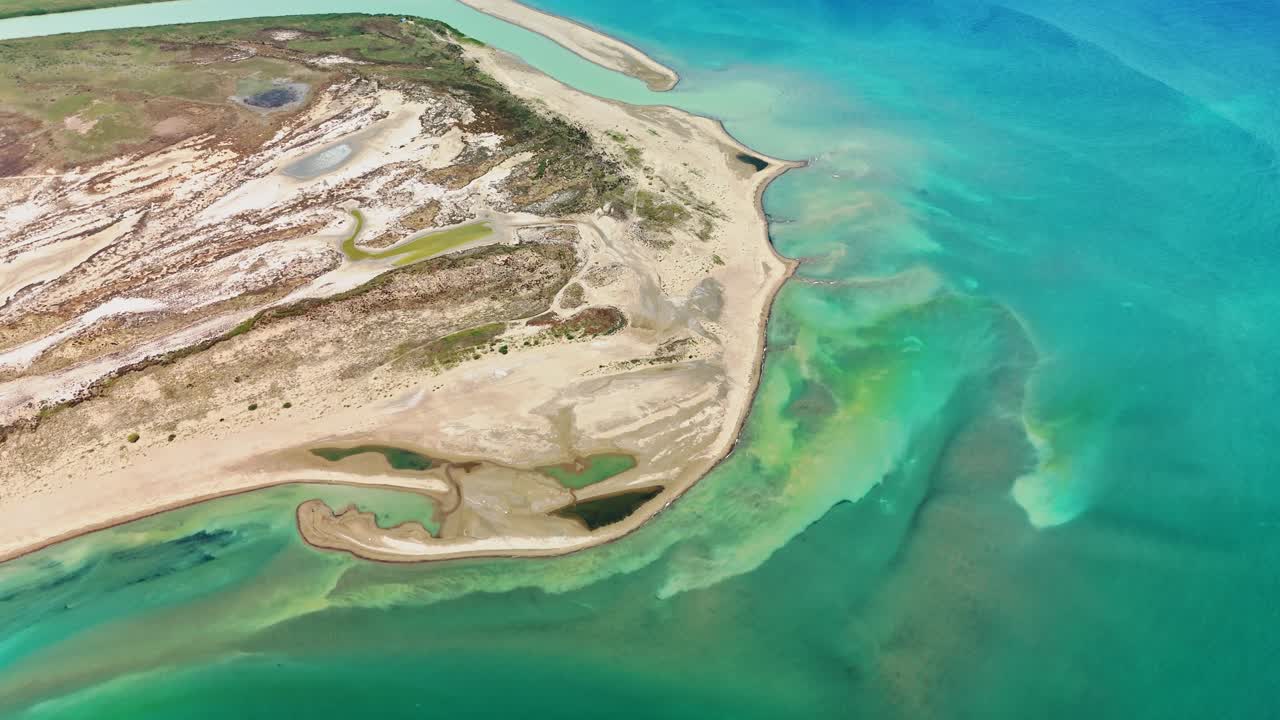 Aerial view of turquoise ocean meeting sandy coastline, peaceful atmosphere