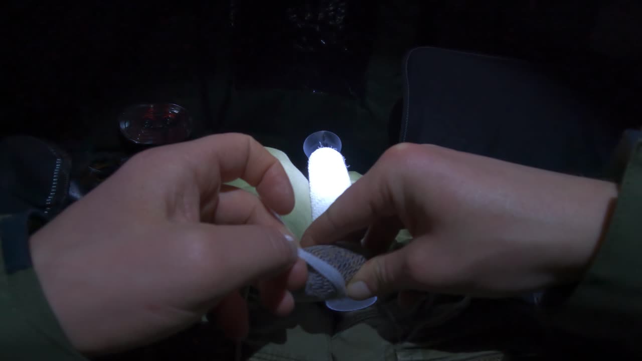 Carp fishing with PVA bags at night, capturing angler’s focused moment