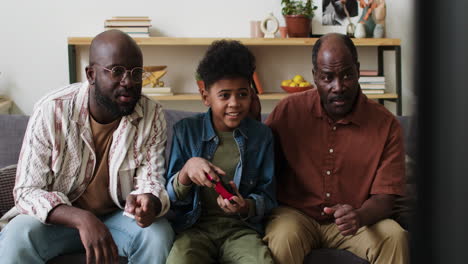 boy playing video games with family