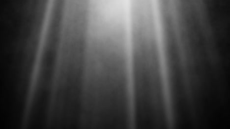 smoke and light rays against black background in monochrome – cinematic fog with glowing sunrays – mystical light and shadows in black and white