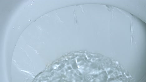 water-is-swirling-in-the-toilet-flush-to-clean-and-water-being-flushed-in-a-toilet-bowl