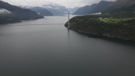 closing up drone footage of hardanger suspension bridge over a fjord