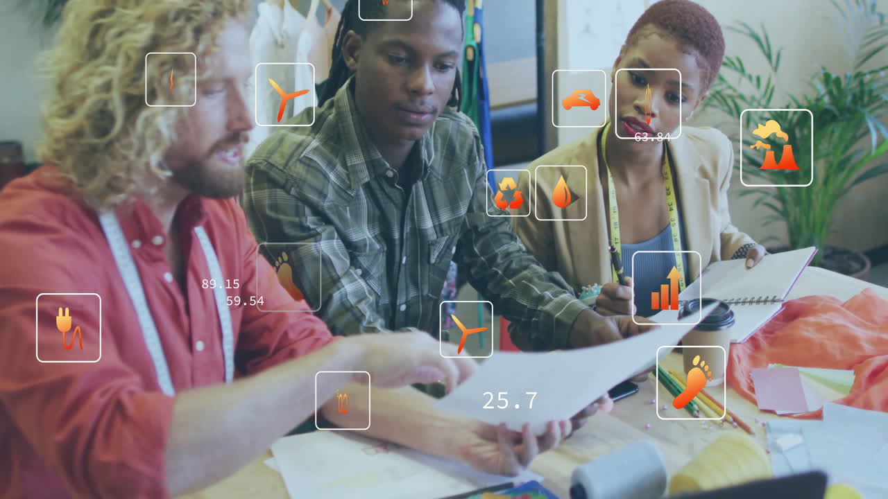 Animation of multiple icon in squares over diverse designers discussing about design in office
