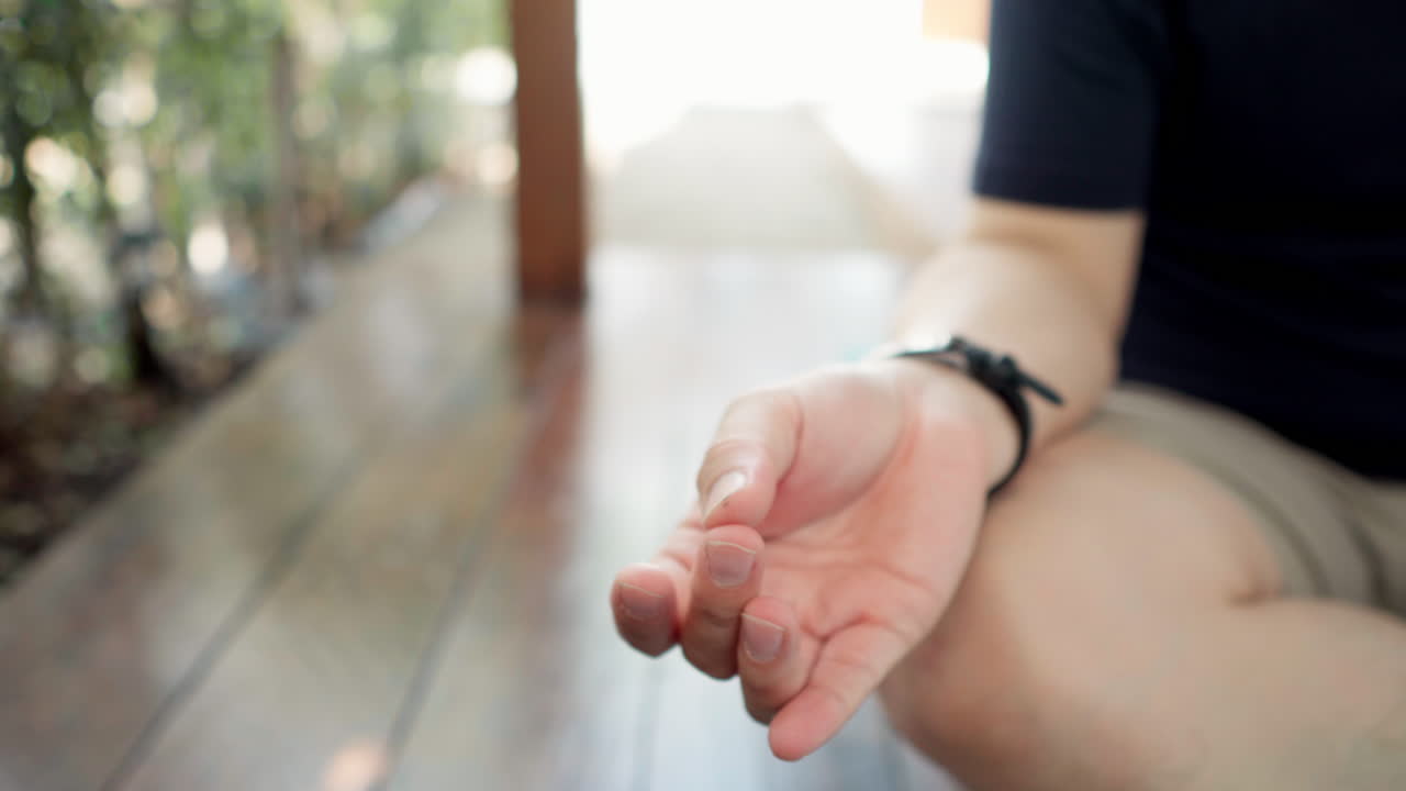 Close up of Asian man's hand practice mindful relaxing yoga exercise