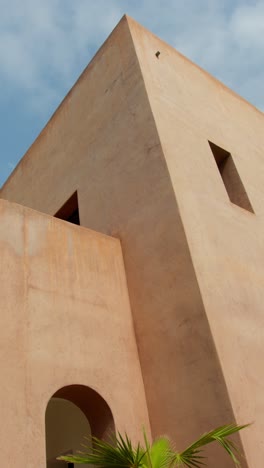 marrakesh building exterior under blue sky, calm atmosphere, simple design