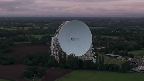 lovell telescope at jodrell bank observatory, set in a lush green landscape