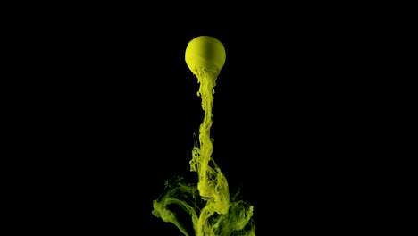 green ink paint slowly flows from the ball