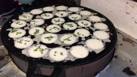 cooking concept. kind of thai sweetmeat . coconut milk mix with powder fried dessert at thai night street food market. dessert of thai traditional sweetmeat, pancake, pudding. 4k footage.