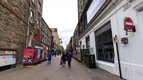 people walking on a busy street in edinburgh